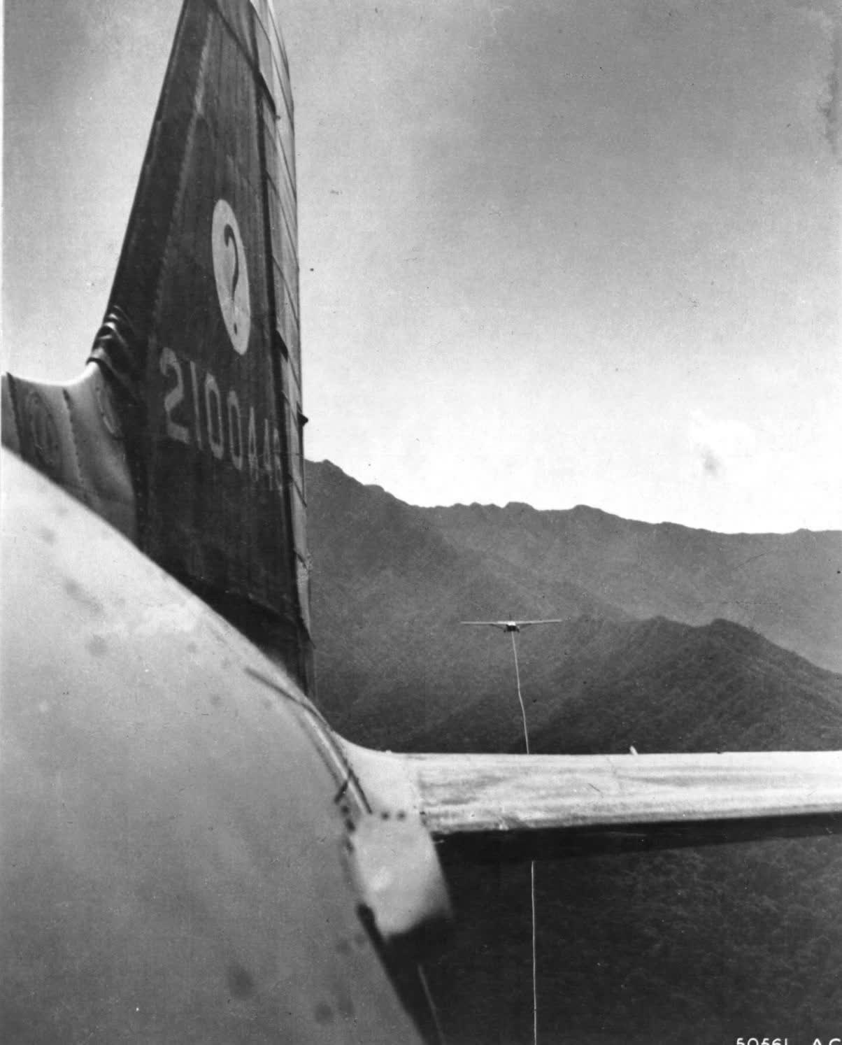 The glider is on tow 8,000 ft. in the sky over the Chiba Hills, which form a natural barrier between Japanese and Allied territory
